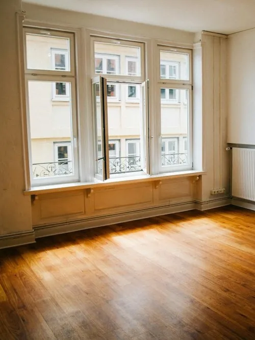 Piso vacío y luminoso con suelo de madera, listo para entregar las llaves